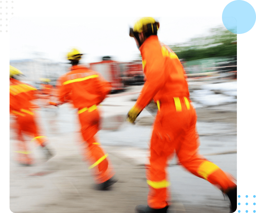 A group of people in orange suits are running.