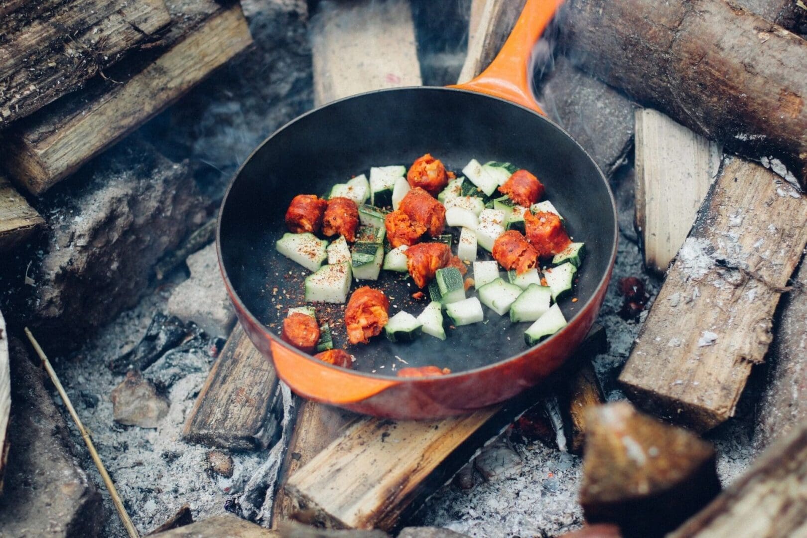 A pan of food on the ground cooking.